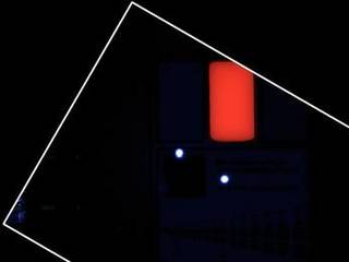 During pre-flight testing in March 2011, the Mars Hand Lens Imager (MAHLI) camera on NASA's Mars rover Curiosity took this image of the MAHLI calibration target under illumination from MAHLI's two ultraviolet LEDs (light emitting diodes).