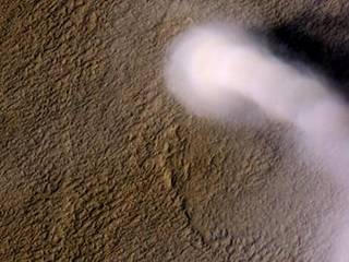 A Martian dust devil roughly 12 miles (20 kilometers) high was captured winding its way along the Amazonis Planitia region of Northern Mars on March 14, 2012 by the High Resolution Imaging Science Experiment (HiRISE) camera on NASA's Mars Reconnaissance Orbiter.