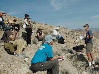 A group of journalists take part in a field trip to learn about the clues hidden in the rock layers with Curiosity Project Scientist, John Grotzinger.