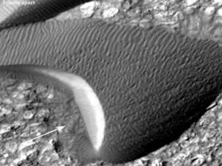 Back-and-forth blinking of this two-image animation shows movement of a sand dune on Mars. The images are part of a study published by Nature on May 9, 2012, reporting movement of Martian sand dunes at about the same flux (volume per time) as movement of dunes in Antarctica on Earth.