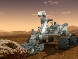 In this picture, the rover examines a rock on Mars with a set of tools at the end of the rover's arm, which extends about 7 feet (2 meters).
