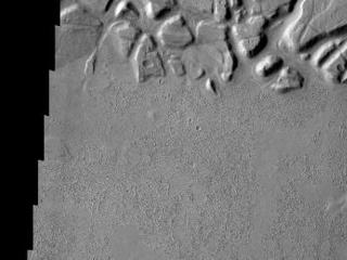 Echus Chasma forms the boundary between the Tharsis volcanoes to the west and Lunae Planum to the east. This region is one of both tectonically fractured rocks (top of image) and volcanic flows (middle and bottom of image). Echus Chasma empties into Kasei Valles.