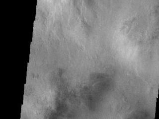 The floor of this unnamed crater in Aonia Terra has been filled with multiple layers of material.