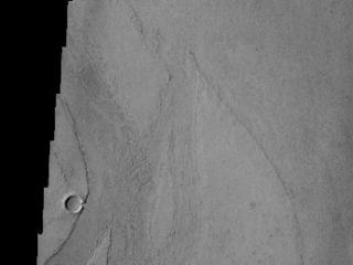 Marte Vallis, located in Amazonis Planitia, is broad and shallow. The streamlined islands at the top and bottom of the image illustrate this.