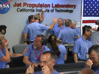 Engineers at NASA's Jet Propulsion Laboratory in Pasadena, Calif., celebrate the landing of NASA's Curiosity rover on the Red Planet. The rover touched down on Mars the evening of Aug. 5 PDT (morning of Aug. 6 EDT).