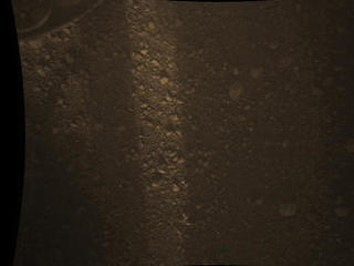 This full-resolution color image from NASA's Curiosity Rover shows the gravel-covered surface of Mars. It was taken by the Mars Descent Imager (MARDI) several minutes after Curiosity touched down on Mars.