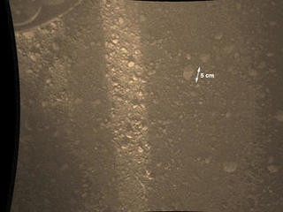 This full-resolution color image from NASA's Curiosity Rover shows the gravel-covered surface of Mars. It was taken by the Mars Descent Imager (MARDI) several minutes after Curiosity touched down on Mars.