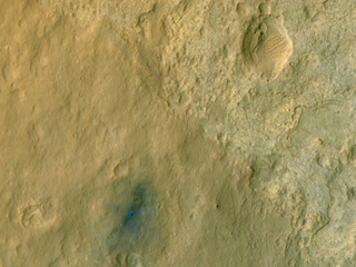 This color-enhanced view of NASA's Curiosity rover on the surface of Mars was taken by the High Resolution Imaging Science Experiment (HiRISE) on NASA's Mars Reconnaissance Orbiter as the satellite flew overhead.
