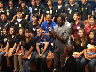 With students and NASA space shuttle astronaut Leland Melvin looking on, musical artist will.i.am posts a tweet soon after his song "Reach for the Stars" was beamed back from the Curiosity Mars rover and broadcast to a live audience at NASA's Jet Propulsion Laboratory in Pasadena, Calif.