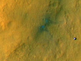 Tracks from the first drives of NASA's Curiosity rover are visible in this image captured by the High-Resolution Imaging Science Experiment (HiRISE) camera on NASA's Mars Reconnaissance Orbiter.