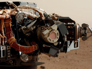 The left eye of the Mast Camera (Mastcam) on NASA's Mars rover Curiosity took this image of the camera on the rover's arm, the Mars Hand Lens Imager (MAHLI), during the 30th Martian day, or sol, of the rover's mission on Mars (Sept. 5, 2012).