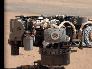 This image shows the Alpha Particle X-Ray Spectrometer (APXS) on NASA's Curiosity rover, with the Martian landscape in the background.