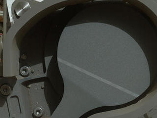 This image from NASA's Curiosity rover shows the cover on an inlet that will receive powdered rock and soil samples for analysis.