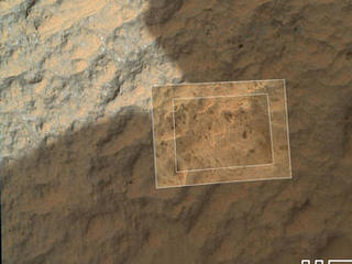 This image combines photographs taken by the Mars Hand Lens Imager (MAHLI) at three different distances from the first Martian rock that NASA's Curiosity rover touched with its arm.