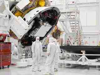 This image shows engineers standing near the rover talking.