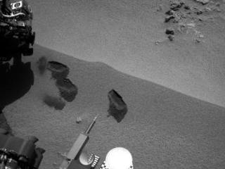 Three bite marks left in the Martian ground by the scoop on the robotic arm of NASA's Mars rover Curiosity are visible in this image taken by the rover's right Navigation Camera during the mission's 69th Martian day, or sol (Oct. 15, 2012).