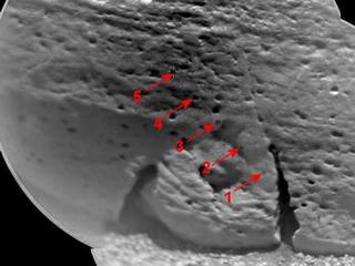 This view of a rock called "Rocknest 3" combines two images taken by the Chemistry and Camera (ChemCam) instrument on the NASA Mars rover Curiosity and indicates five spots where ChemCam had hit the rock with laser pulses to check its composition.