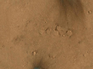 These images from the NASA Mars Reconnaissance Orbiter show several impact scars on Mars made by pieces of the NASA Mars Science Laboratory spacecraft that the spacecraft shed just before entering the Martian atmosphere.