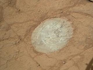 This image from the Mars Hand Lens Imager (MAHLI) on NASA's Mars rover Curiosity shows the patch of rock cleaned by the first use of the rover's Dust Removal Tool (DRT).