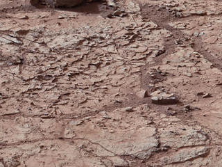 This view shows the patch of veined, flat-lying rock selected as the first drilling site for NASA's Mars rover Curiosity.