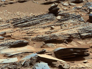 This image from the Mast Camera (Mastcam) on NASA's Mars rover Curiosity shows inclined layering known as cross-bedding in an outcrop called "Shaler" on a scale of a few tenths of meters, or decimeters (1 decimeter is nearly 4 inches).