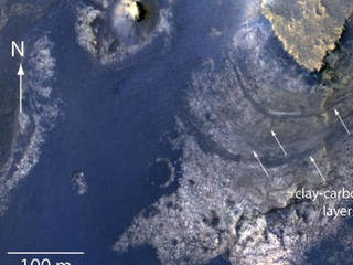This view of layered rocks on the floor of McLaughlin Crater shows sedimentary rocks that contain spectroscopic evidence for minerals formed through interaction with water.