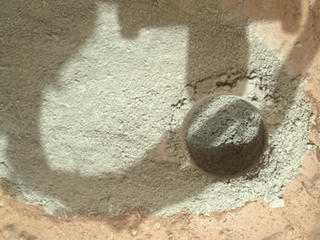 In an activity called the "mini drill test," NASA's Mars rover Curiosity used its drill to generate this ring of powdered rock for inspection in advance of the rover's first full drilling.