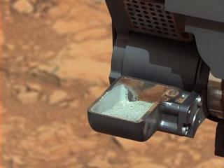 This image from NASA's Curiosity rover shows the first sample of powdered rock extracted by the rover's drill.