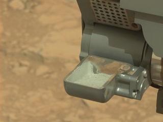 This image from NASA's Curiosity rover shows the first sample of powdered rock extracted by the rover's drill.