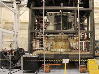 The MAVEN spacecraft structure is placed into a reaction chamber, where it completed a static loads test to ensure that it will withstand the extreme forces of launch.