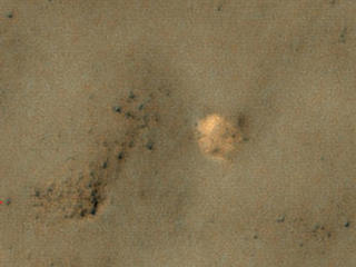The bright feature in this image might be the parachute from a 1971 Soviet Mars lander named Mars 3.  The image was taken by the High Resolution Imaging Science Experiment (HiRISE) camera on NASA's Mars Reconnaissance Orbiter.
