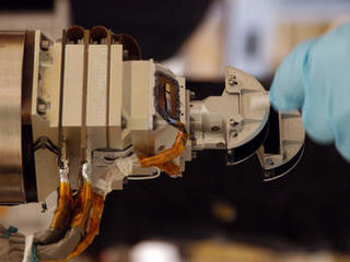 The Mars Color Imager (MARCI), shown here with a gloved hand for scale, is designed to produce a global map to help characterize daily, seasonal and year-to-year variations in Mars' climate, providing a daily weather report for Mars.