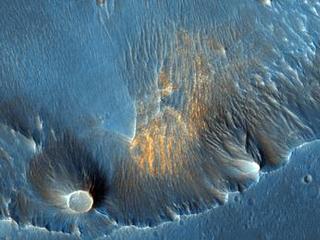 In this HiRISE image taken within Capri Chasma, TES also detected the same crystalline gray hematite like that found at Meridiani Planum.