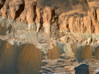 This observation shows erosional features on light-toned rocks in Aram Chaos, a crater near the equator of Mars that has been nearly filled with sedimentary rocks.