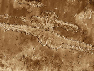 This mosaic image of Valles Marineris - colored to resemble the martian surface - comes from the Thermal Emission Imaging System (THEMIS), a visible-light and infrared-sensing camera on NASA's Mars Odyssey orbiter.
