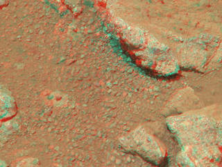 This stereo view from NASA's Mars rover Curiosity shows a rock called "Link," which bears rounded pebbles that provide evidence about vigorous flow of water in a stream on ancient Mars.