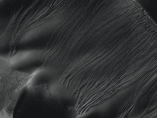 Several types of downhill flow features have been observed on Mars. This image from the High Resolution Imaging Science Experiment (HiRISE) camera on NASA's Mars Reconnaissance Orbiter is an example of a type called "linear gullies."