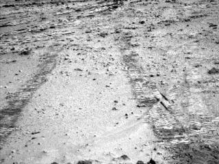 This view from the left Navigation Camera (Navcam) of NASA's Mars Rover Curiosity looks back at wheel tracks made during the first drive away from the last science target in the "Glenelg" area.