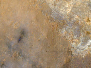 NASA's Mars Science Laboratory rover Curiosity appears as a bluish dot near the lower right corner of this enhanced-color view from the High Resolution Imaging Science Experiment (HiRISE) camera on NASA's Mars Reconnaissance Orbiter.