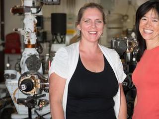 Pictured here are Jennifer Trosper, MSL Deputy Project Manager and Grace Tan-Wang, Strategic Uplink Lead.  The image was taken in the "Mars Yard" where the ground test model of the Curiosity rover is housed.