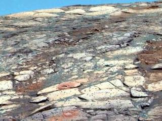 This view from the Mars Exploration Rover Opportunity's panoramic camera is a false-color composite rendering of the first seven holes that the rover's rock abrasion tool dug on the inner slope of "Endurance Crater."
