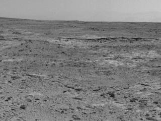 The low ridge that appears as a dark band below the horizon in the center of this scene is a Martian outcrop called "Cooperstown," a possible site for contact inspection with tools on the robotic arm of NASA's Mars rover Curiosity.