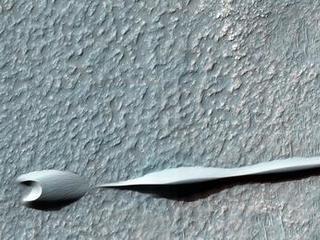 Sand dunes such as those seen in this image have been observed to creep slowly across the surface of Mars through the action of the wind.