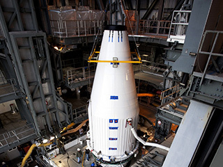 Crews guide NASA's Mars Atmosphere and Volatile EvolutioN, or MAVEN, spacecraft, inside a payload fairing, into place atop a United Launch Alliance Atlas V rocket at the Vertical Integration Facility at Space Launch Complex 41.