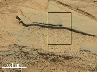 The rock "Ithaca" shown here, with a rougher lower texture and smoother texture on top, appears to be a piece of the local sedimentary bedrock protruding from the surrounding soil in Gale Crater.