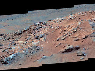 Gazing across the landscape of the "Columbia Hills" in Gusev Crater on Mars, scientists saw hints of tilted rock layers across the area traversed by the Spirit rover.