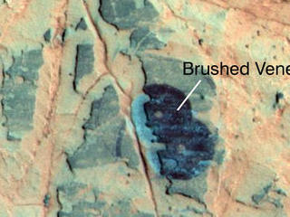 Researchers used NASA's Mars Exploration Rover Opportunity to find a water-related mineral on the ground that had been detected from orbit, and found it in the dark veneer of rocks on the rim of Endeavour Crater.