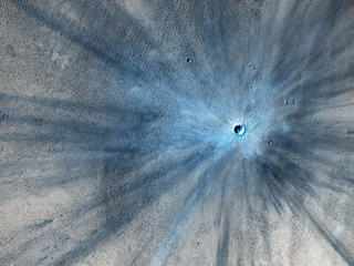 A dramatic, fresh impact crater dominates this image taken by the High Resolution Imaging Science Experiment (HiRISE) camera on NASA's Mars Reconnaissance Orbiter on Nov. 19, 2013.