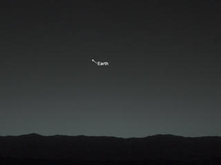 This view of the twilight sky and Martian horizon taken by NASA's Curiosity Mars rover includes Earth as the brightest point of light in the night sky.