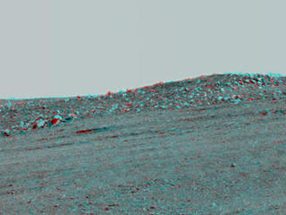 The boulder-studded ridge in this scene recorded by NASA's Mars Exploration Rover Opportunity is "McClure-Beverlin Escarpment," informally named for Jack Beverlin and Bill McClure, engineers who on Feb. 14, 1969, risked their lives to save NASA's second successful Mars mission, Mariner 6, on its launch pad.